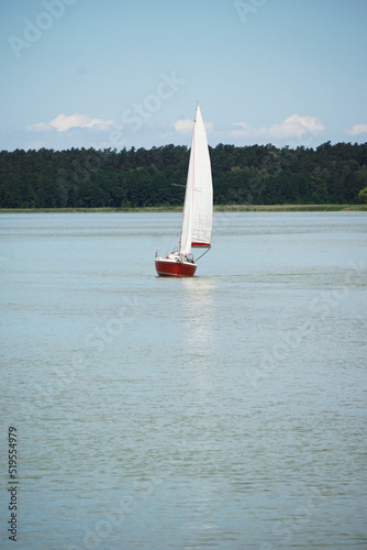 Fototapeta Naklejka Na Ścianę i Meble -  Sailboat swimming on a lake - front view