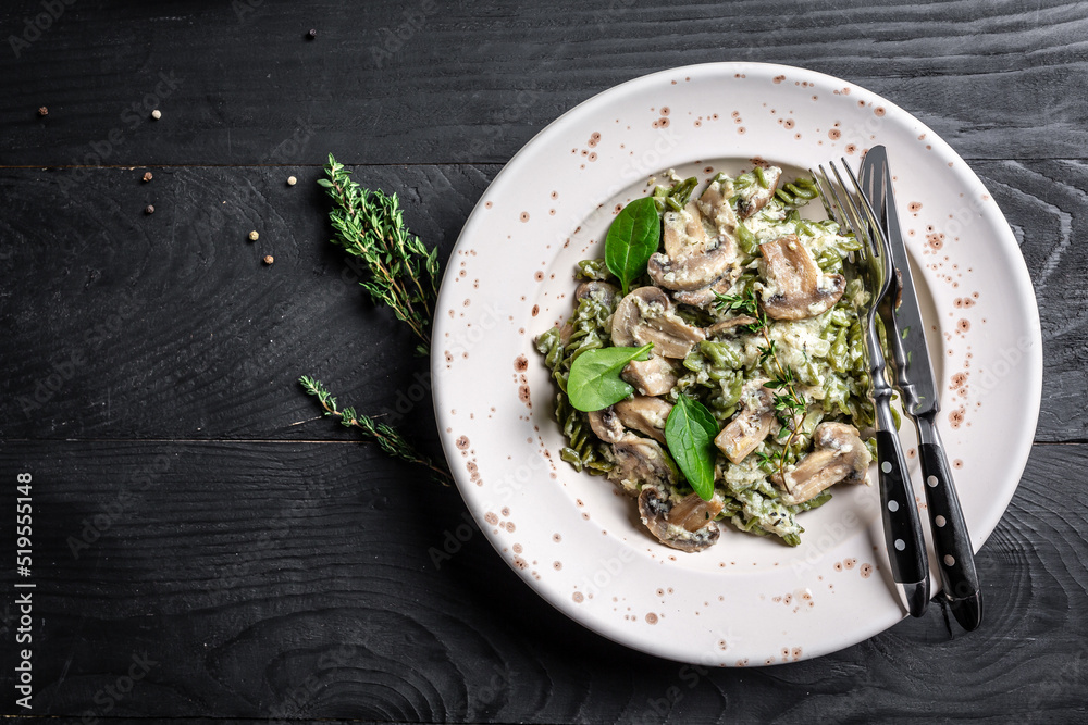 Mushroom and Spinach Pasta in a Bowl, Vegan Food on light background. Vegan or gluten free diet. banner, menu recipe place for text, top view Mushroom and Spinach Pasta in a Bowl, Vegan Food on light background. Vegan or gluten free diet. banner, menu recipe place for text, top view