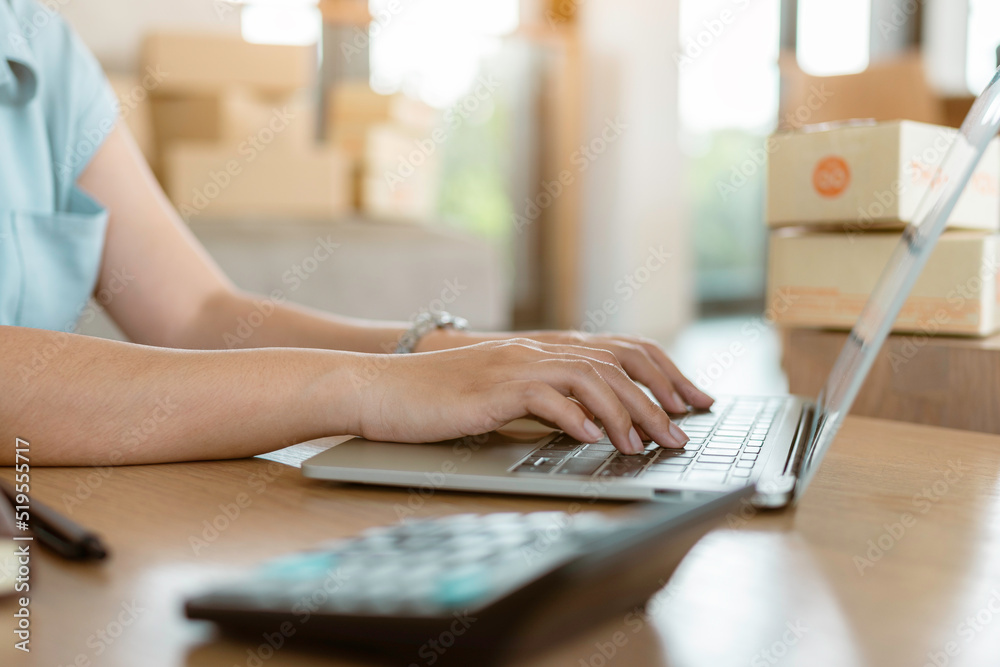 Close up online business owner prepares product for delivery to the customer. Online entrepreneur checking retail order on website. small business owner, SME concept. Close up online business owner prepares product for delivery to the customer. Online entrepreneur checking retail order on website. small business owner, SME concept.