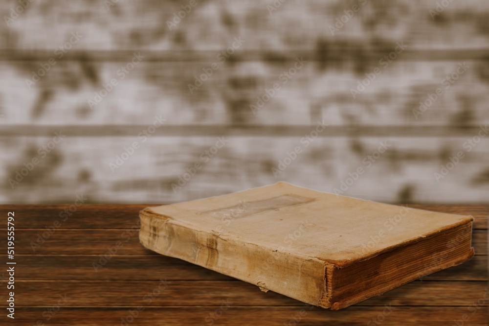 A retro old book on a wooden table.