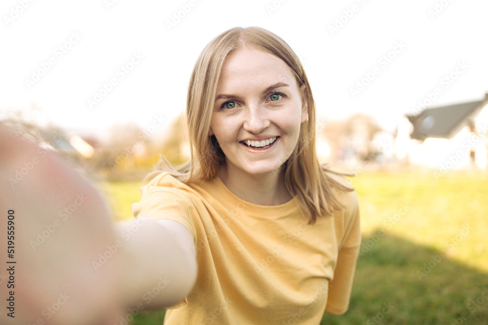 Excited happy young woman enjoys free time and walking in city park, make selfie by camera poses has fun Excited happy young woman enjoys free time and walking in city park, make selfie by camera poses has fun