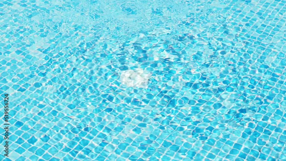 The surface of the pool, the background of the water in the pool. texture of moving transparent water in a blue pool. Water in a swimming pool with light reflections and water movement from filtration The surface of the pool, the background of the water in the pool. texture of moving transparent water in a blue pool. Water in a swimming pool with light reflections and water movement from filtration