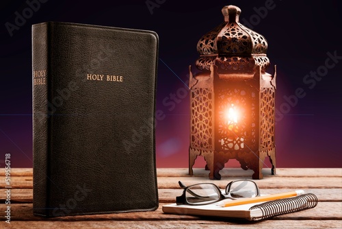 Fototapeta A lamp illuminated closed Holy Book
