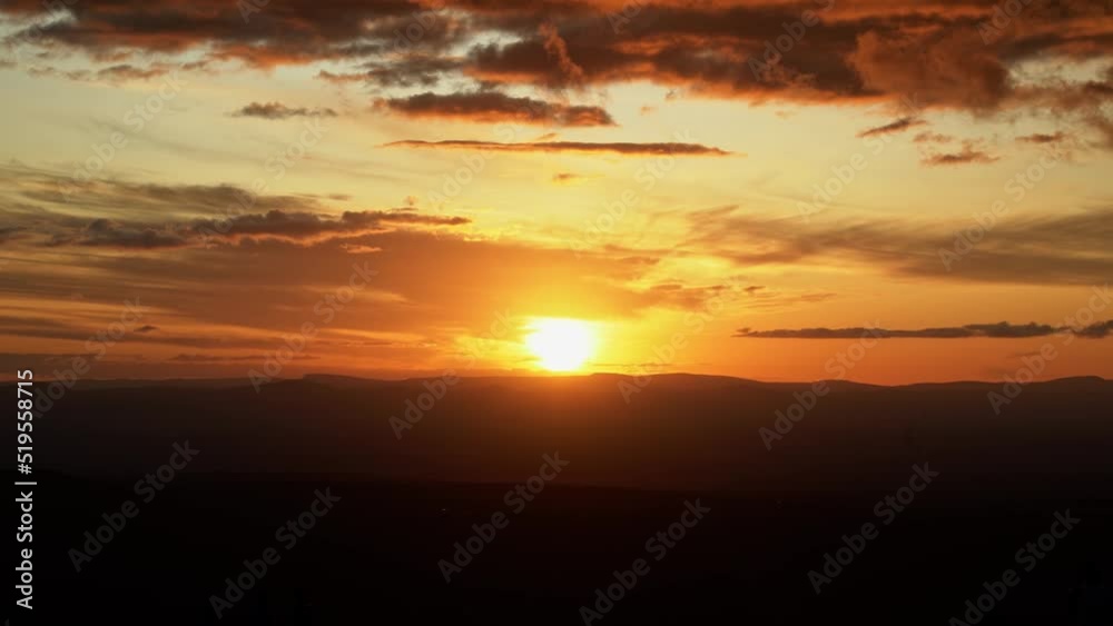 Tilting down shot revealing a beautiful vivid golden sunset from the top of the famous Morro Pai Inacio in the Chapada Diamantina National Park in Bahia Northeastern Brazil on a warm summer evening. Tilting down shot revealing a beautiful vivid golden sunset from the top of the famous Morro Pai Inacio in the Chapada Diamantina National Park in Bahia Northeastern Brazil on a warm summer evening.