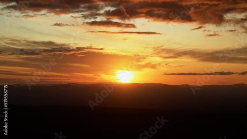 Tilting down shot revealing a beautiful vivid golden sunset from the top of the famous Morro Pai Inacio in the Chapada Diamantina National Park in Bahia Northeastern Brazil on a warm summer evening. photo