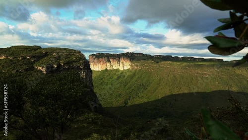 Panning left shot revealing the stunning Capao Valley with large plateaus from the Mount of Pai Inácio hike in the Chapada Diamantina national park in northern Brazil on a warm summer evening. photo