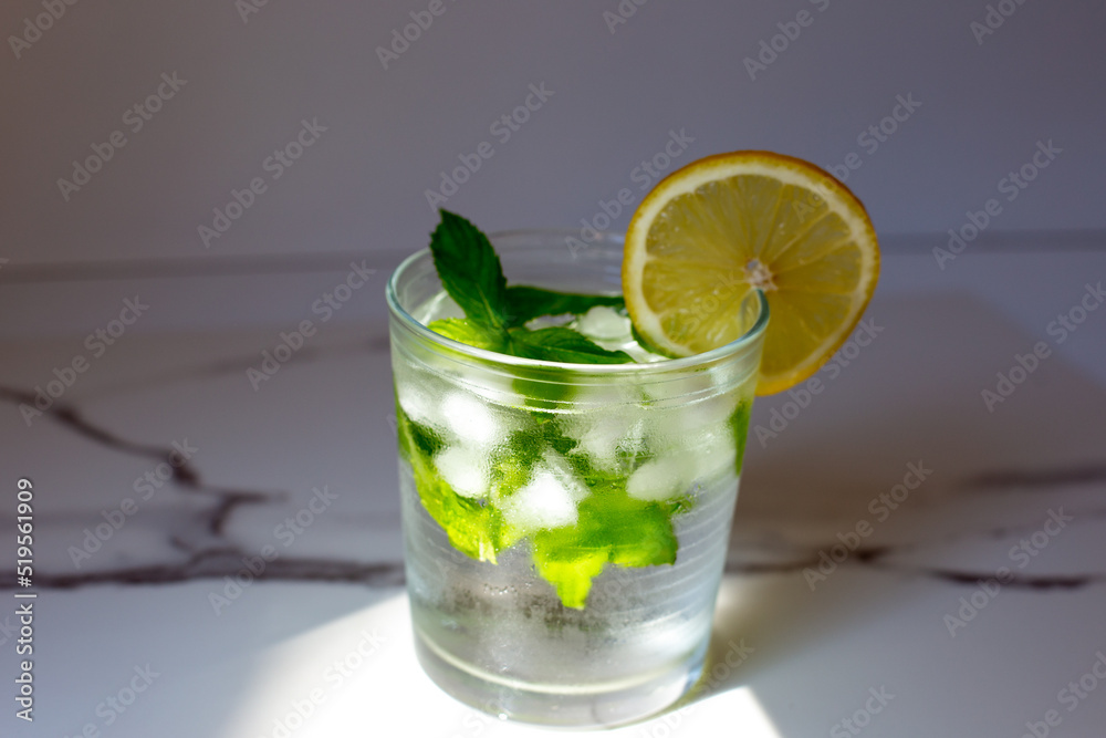 Fototapeta premium glass of cold water with fresh mint leaves and ice cubes