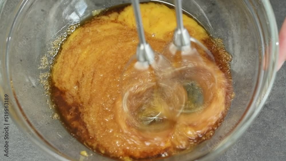 The chef mixing egg yolks, brown sugar and Marsala wine with electric mixer.
The chef mixing egg yolks, brown sugar and Marsala wine with electric mixer.