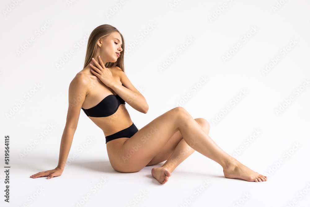 Young woman in black lingerie over white background