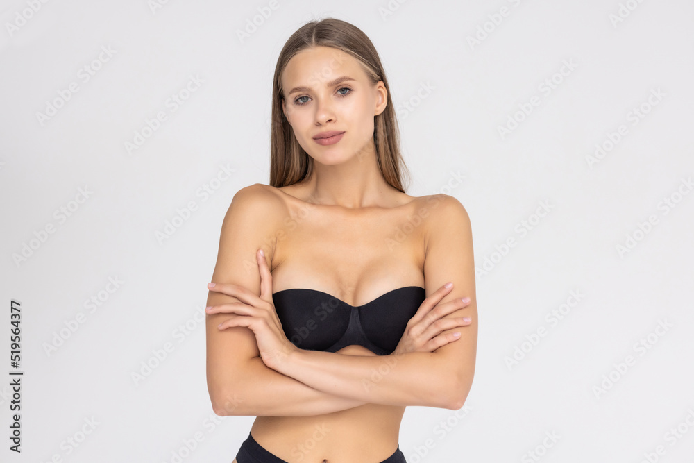 Fototapeta premium Beautiful and sexy woman wearing black lingerie isolated on white background