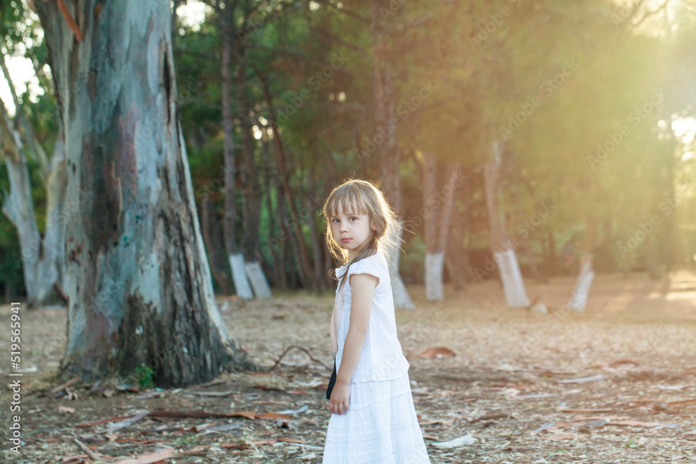Portrait of a pretty 6 year old child girl in white dress, natural light. Portrait of a pretty 6 year old child girl in white dress, natural light.