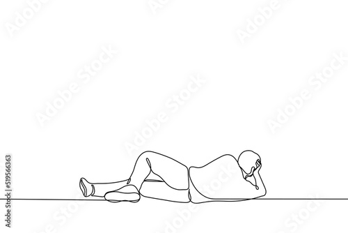 man lies on his side props his head up with his hand - one line drawing vector. concept procrastination, laziness, observation, rest