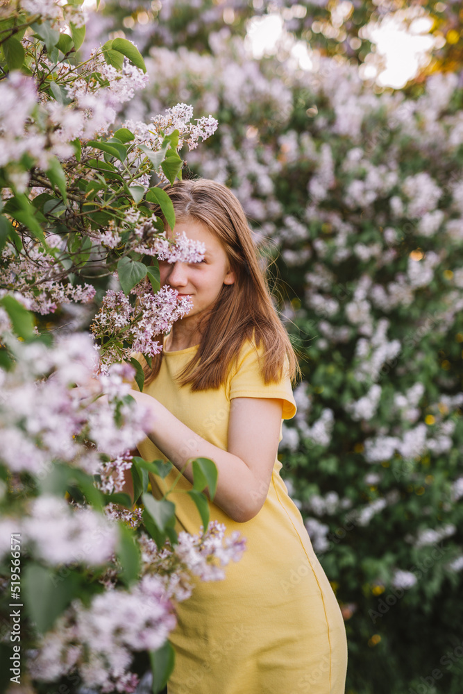 teenage girl with blond hair enjoys nature. The girl is wearing a yellow summer dress. teenage girl with blond hair enjoys nature. The girl is wearing a yellow summer dress.