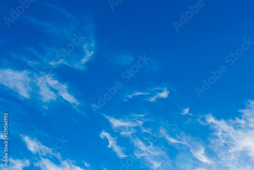 Bright blue sky in the evening with white soft clouds natural background weather air © Andrey