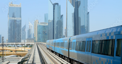Dubai, OAE, July 23, 2022 - the subway train rides on skyscrapers background