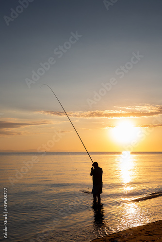 Silhouette Of Fisherman In Sunrise