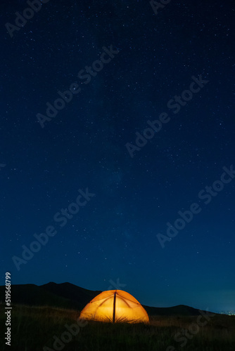 Starry sky above a tourist tent in the mountains. © Vitalfoto