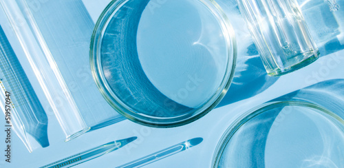 serum in petri dishes on light blue background cosmetic research concept