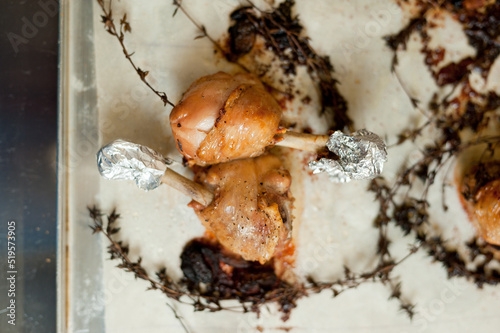 Cook preparing chicken confit leg.