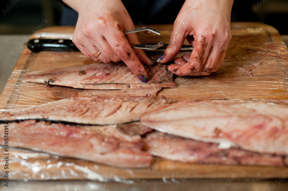 The cook separates the fillet from the fish and clears it from the bones. Mackerel fillets.