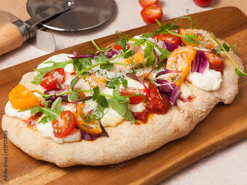 vegetarian pizza on Roman dough with tomatoes, mozzarella, parmesan and herbs