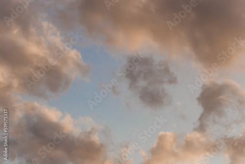 Soft airy warm yellow sunlight clouds sky blue evening natural background
