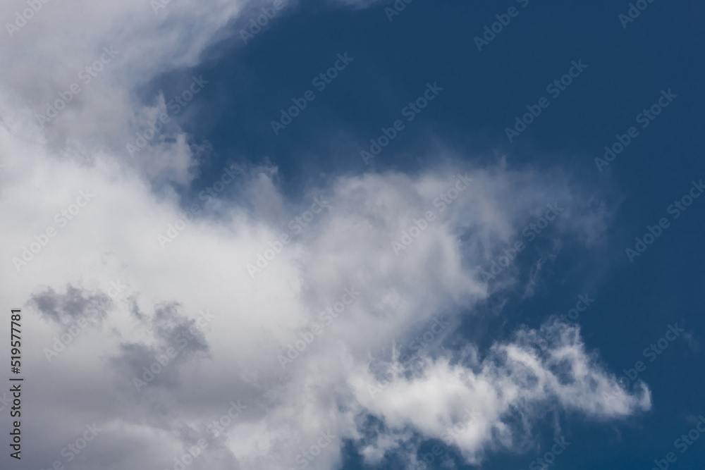White cumulus clouds against a dark blue sky natural background weather change wind White cumulus clouds against a dark blue sky natural background weather change wind