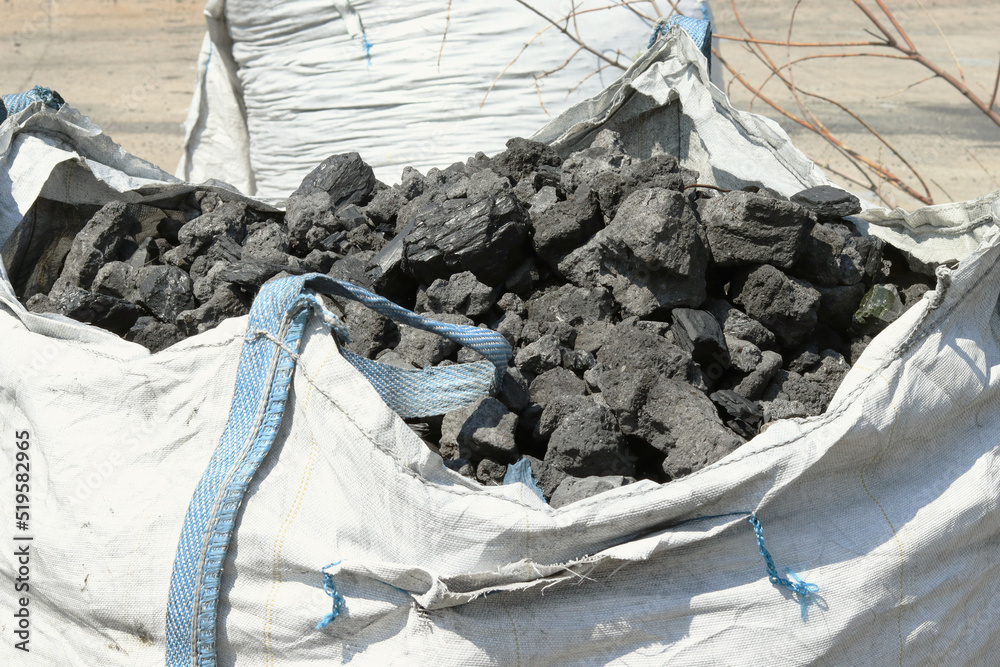 Coal in a big bag.Close-up of a fossil fuel ready for a furnace. selective focus