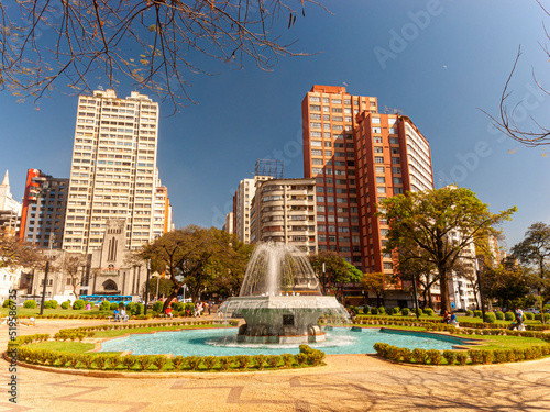 Central panorama of the city of Belo Horizonte. Raul Soares Square. Trees, fountain, blue sky and beautiful residential and commercial buildings.