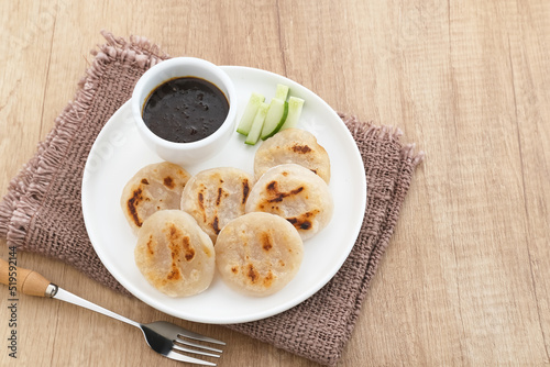 Pempek Tunu or Pempek Panggang, traditional food from South Sumatra, Indonesia. This fish-based food is very popular. Served with cuko sauce.
 photo