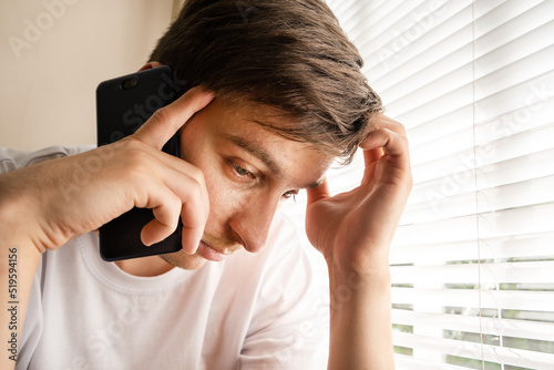 Sad Young Man with a Phone