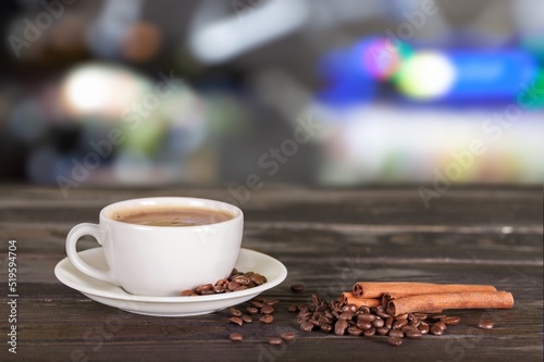 A cup with tasty aroma coffee on wooden table