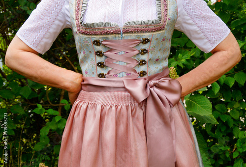 a woman in a beautiful traditional Bavarian dirndl dress at the Bavarian October fest (Oktoberfest) (Munich, Bavaria, Germany)	