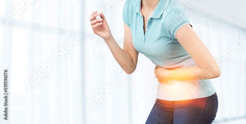 Young woman put her hand on her stomach because she had a very bad stomachache. menstrual pain, gastritis concept photo