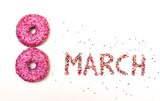 International Women's Day, March 8 holiday written with sweet donuts on a white background