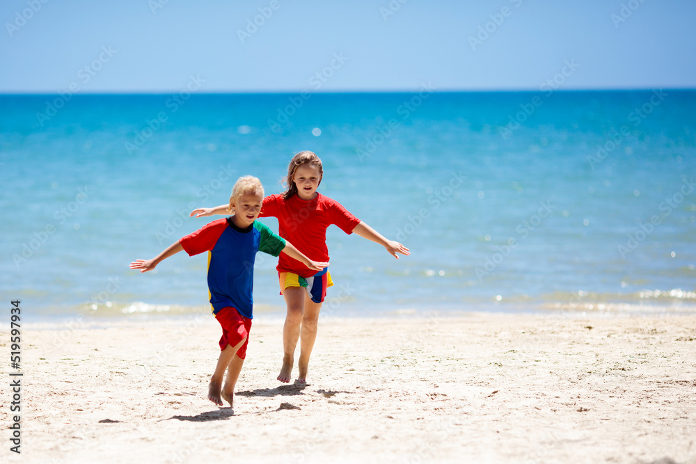 Kids playing on beach. Children play at sea.