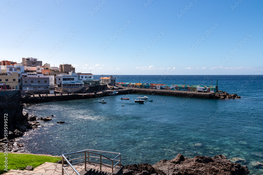 Panoramic view on small fishermen coastal village Los Abrigos, Tenerife, Canary Islands, Spain, Europe, EU. Coastline of Atlantic Ocean. Small boats floating in the turquoise water of the marina Panoramic view on small fishermen coastal village Los Abrigos, Tenerife, Canary Islands, Spain, Europe, EU. Coastline of Atlantic Ocean. Small boats floating in the turquoise water of the marina
