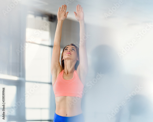 Active young sporty girl doing aerobics and pilates in fitness studio