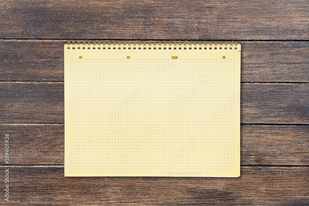 Quote concept with a white notebook page placed on a wooden background. Quote concept with a white notebook page placed on a wooden background.