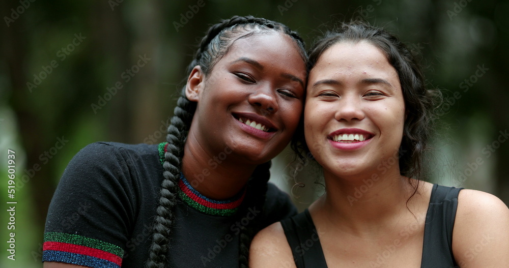 Ethnically diverse girlfriends posing together. African and hispanic girls