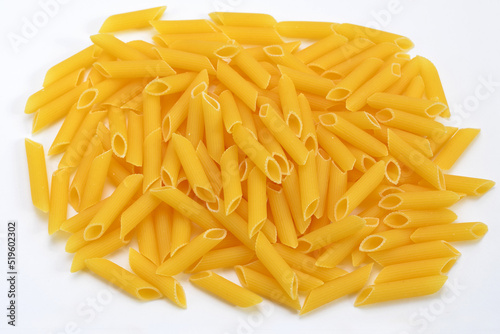 heap of pasta penne rigate durum wheat close up on white background