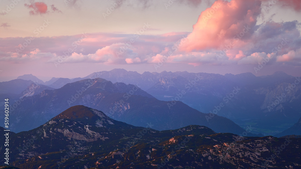 purple hills and mountains of the northern alps in austria at sunset as seen from the Simonyhütte near Dachstein, Summer of 2022