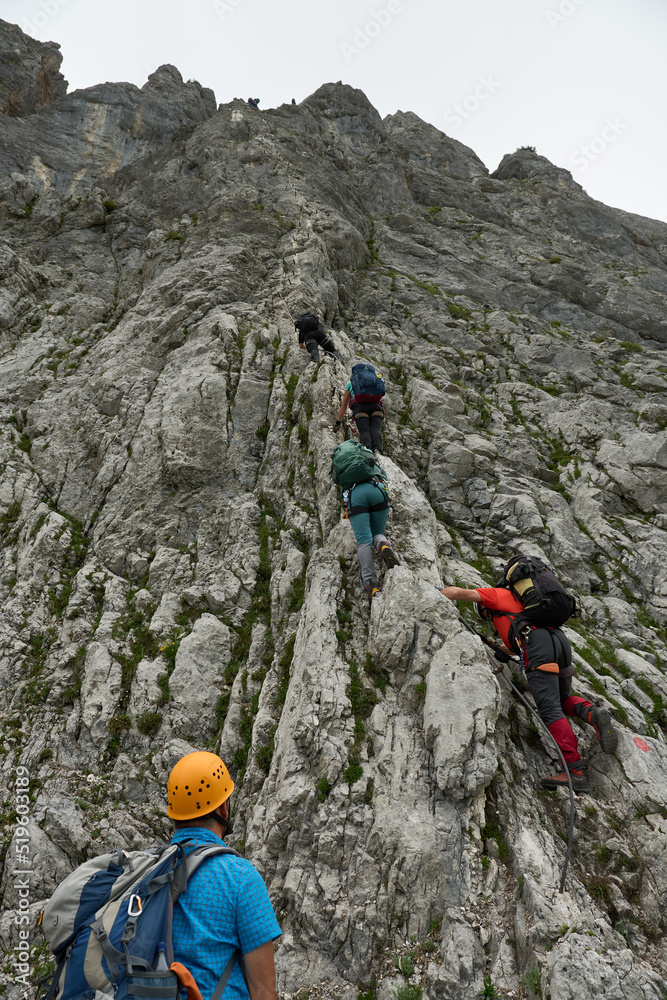 Via Ferrate Anna under Dachstein in the austrian alps with a mixed group of climbers climbing up the klettersteig Via Ferrate Anna under Dachstein in the austrian alps with a mixed group of climbers climbing up the klettersteig