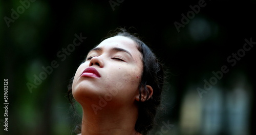 Contemplative young woman closing eyes in meditation. Close-up girl face eye closed