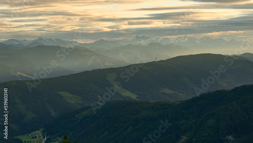 Rolling hills and distant mountains in the setting sun as see from Seethaler Hütte just under Dachstein in the austrian alps, July 2022