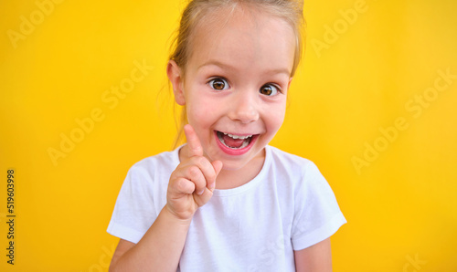 Clever little girl with bright idea pointing upwards her finger gain attention