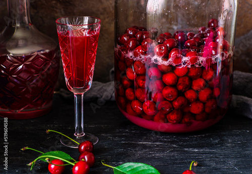 Homemade liqueur from cherries in a jar of a natural fermentation process. Ukrainian tincture.