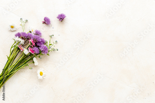 Bunch of wild meadow flowers and herbs chamomile, cornflower and ranunculus. Summer floral background