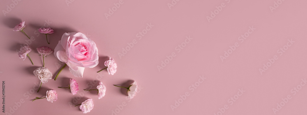 Template for a romantic greeting card with soft pastel pink roses on a pink background. Banner. Floral frame of pink blossoming flowers. Delicate blooming festive light roses.