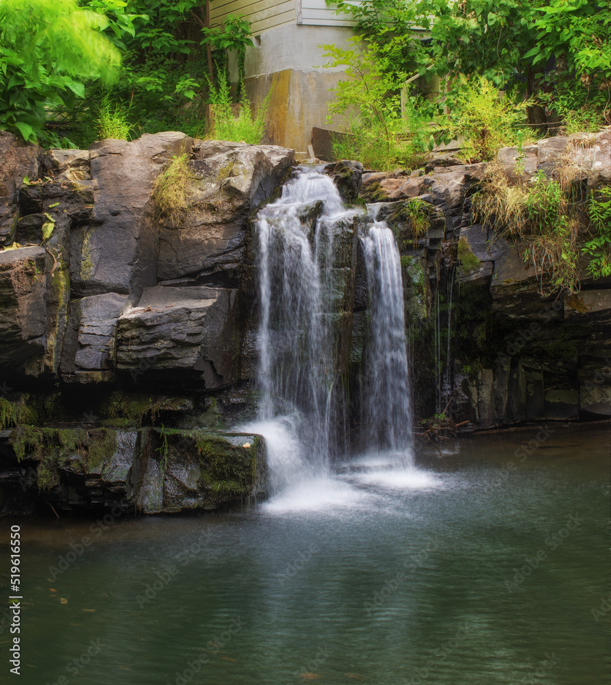 Fototapeta premium A very nice waterfall in the heart of Woodstock NY. Tannery Brook has a nice drop over the rocks on a side street in town in Upstate NY>